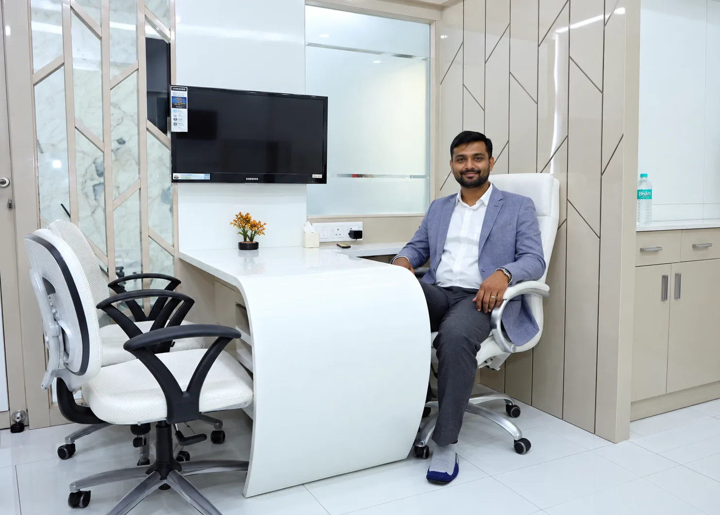 Dr. Girish Bhangale in the consultation cabin at iDent Dental Clinic, Wakad